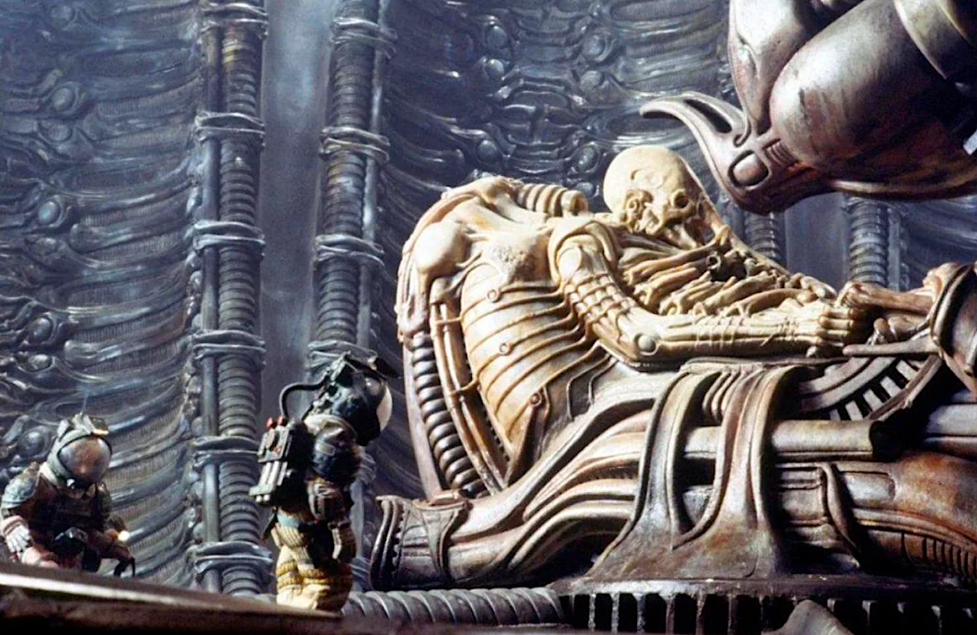 a petrified alien and two tiny astronauts