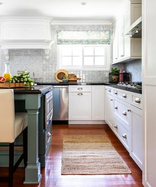 A traditional kitchen with kitchen island and white cabinets