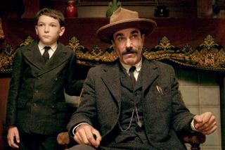Dillon Freasier as H. W. Plainview and Daniel Day-Lewis as Daniel Plainview in a conversation with someone else in There Will Be Blood