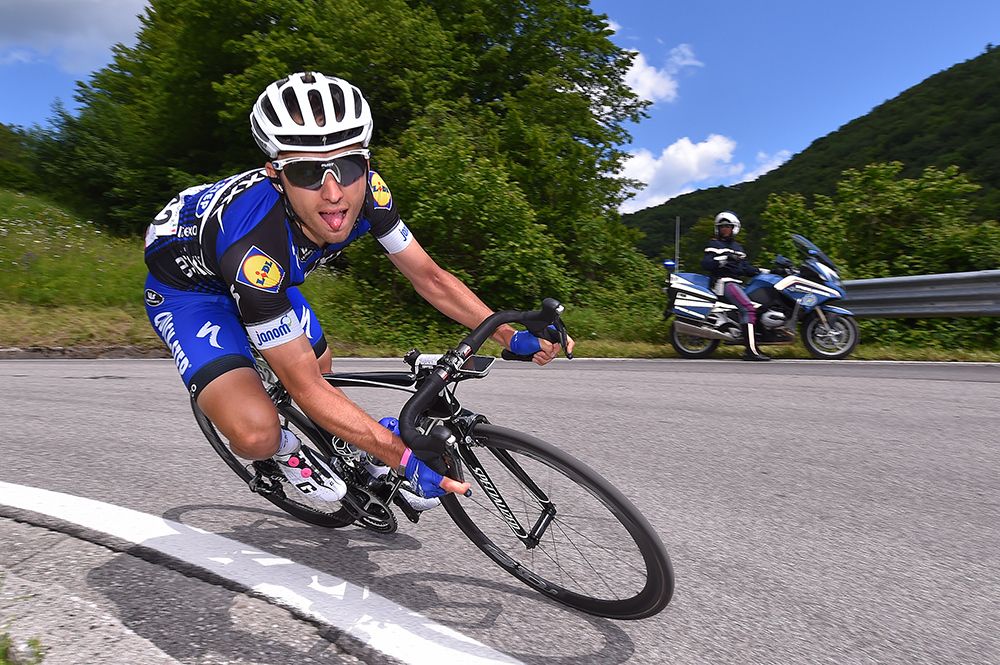 Gianluca Brambilla sticks out his tongue while tacking a tight corner