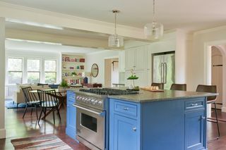 A large sized kitchen with blue painted kitchen cabinets in farrow and ball pitch blue