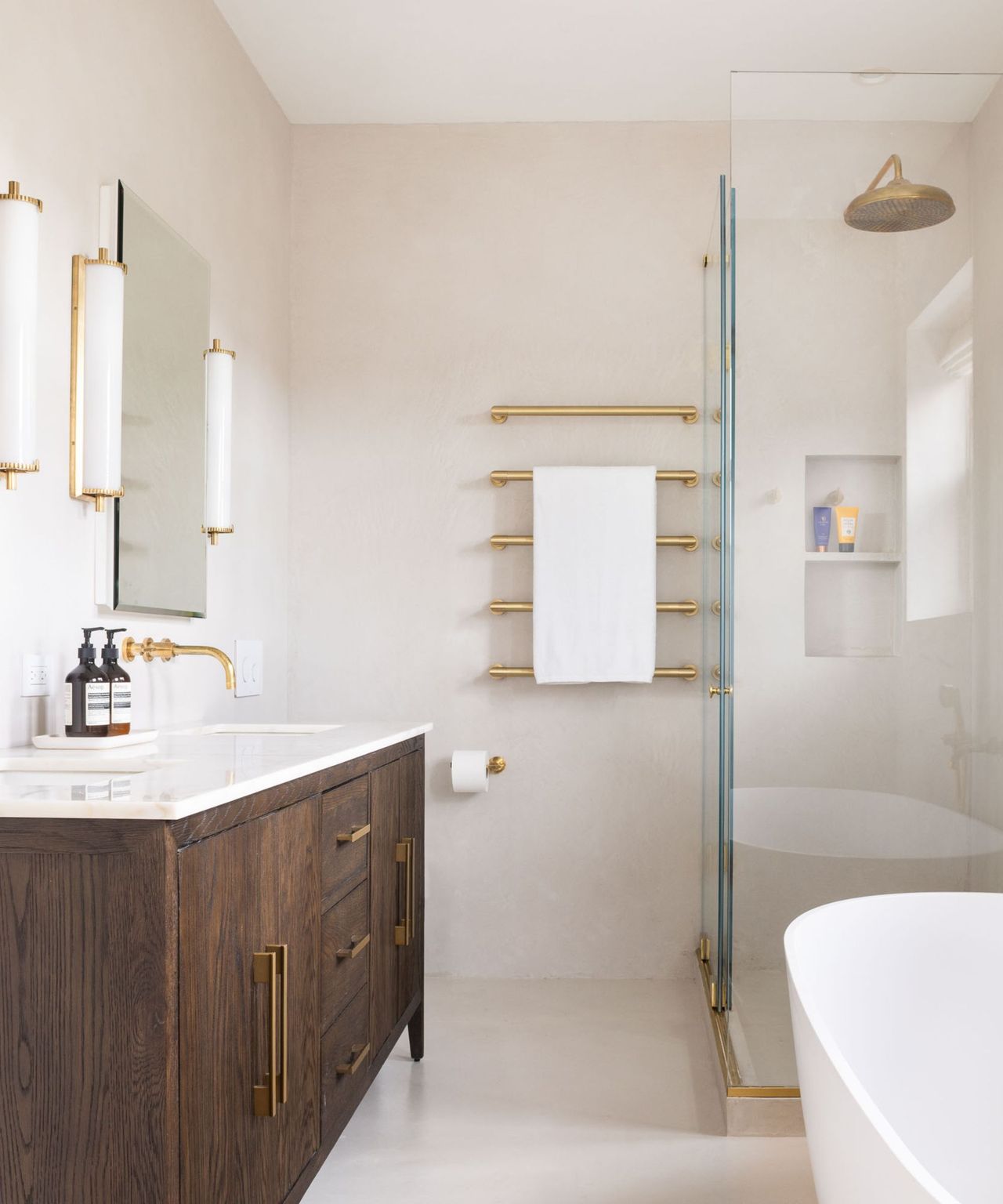 A neutral bathroom with textured walls, a wooden vanity, and a glass shower
