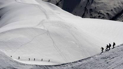 Alpinists walk on the Mont-Blanc Massif in the French Alps