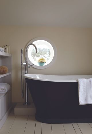 An off-white bathroom with freestanding bath