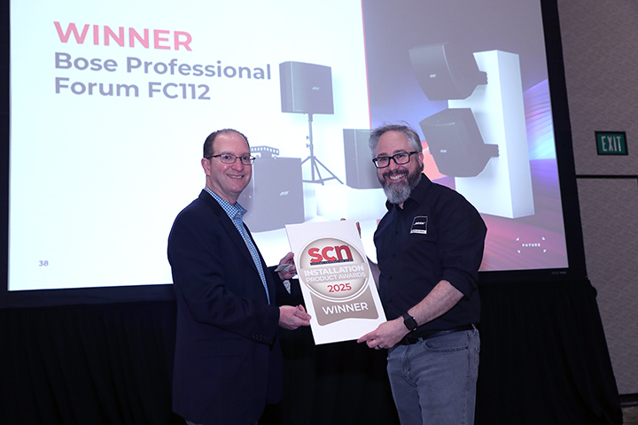 Bose Professional smiles while accepting the SCN Installation Product Award from Adam Goldstein.