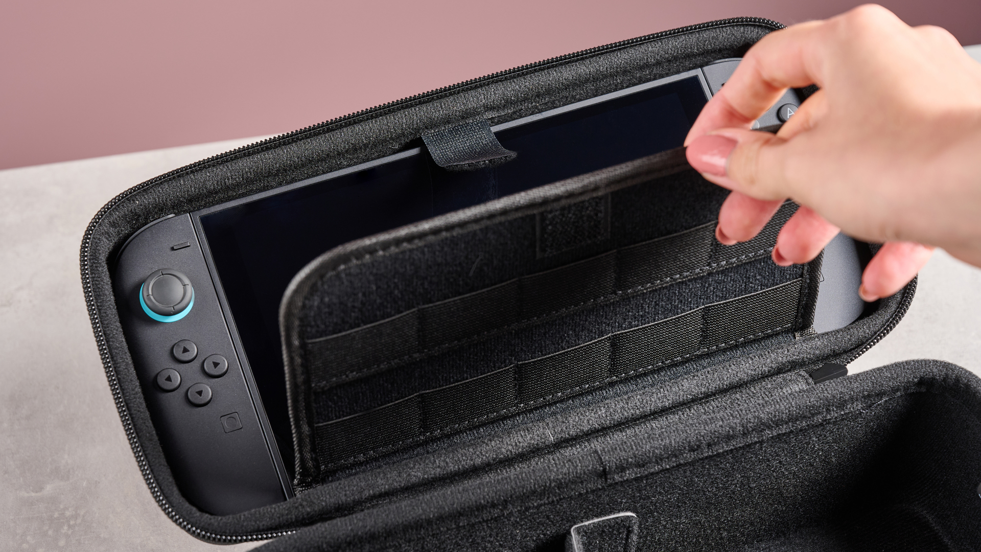 Person lifting game card storage flap on the Nacon Protection Case XL for Nintendo Switch 2