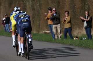 Soudal Quick-step's riders cycle past applauding spectators during the 3rd stage of the Paris-Nice cycling race, a 28,4 km team time trial between Nevers Magny-Cours Circuit and Nevers, on March 11, 2025. (Photo by Anne-Christine POUJOULAT / AFP)