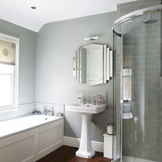 grey bathroom shower area with wooden flooring and wash basin