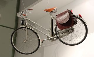 Women’s bicycle with leather furnishings hangs above the space