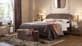 pale pink bedroom with button-backed upholstered bed with matching ottoman showing popular bedroom trends 2023