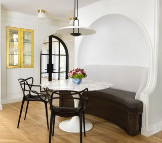 breakfast corner with curved sofa, marble round table and pendant