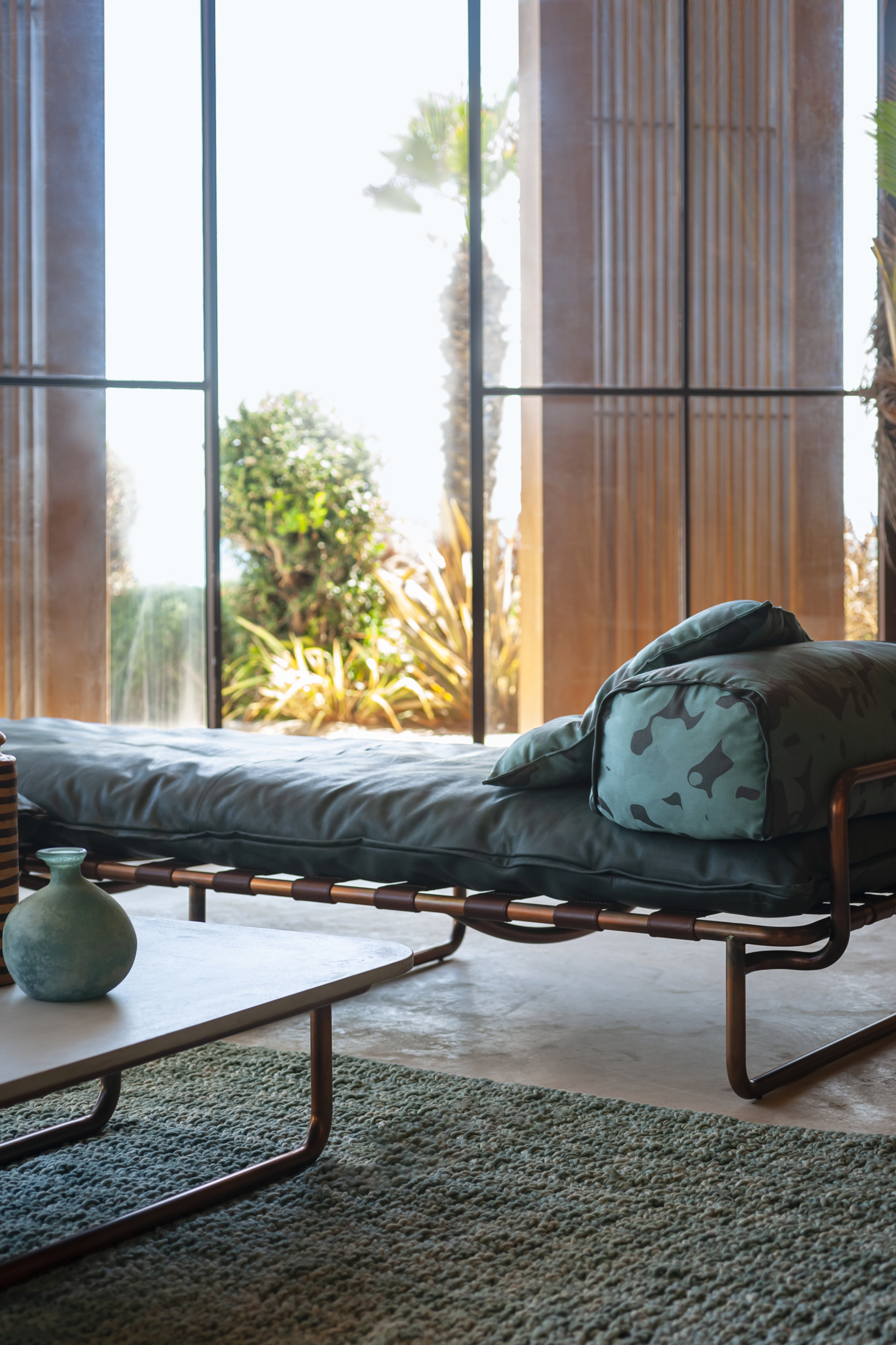 a leather day bed with a printed fabric cushion