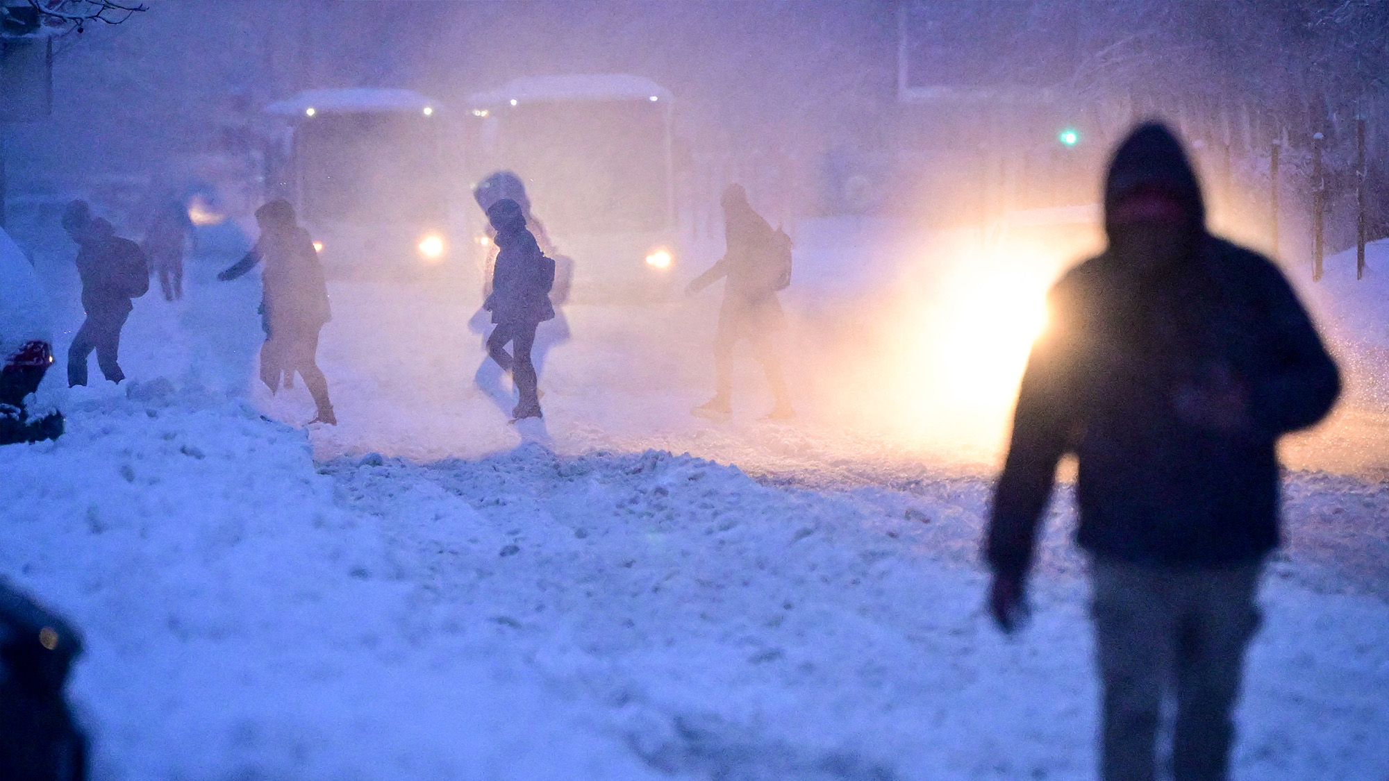 People walk on a boulevard during heavy snowfall in Bucharest, Romania