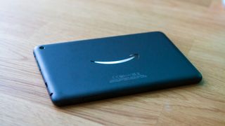Amazon Fire 7 (2022) face-down on table with light on logo