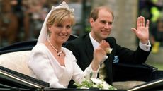 Prince Edward and Sophie wave to well-wishers from a carriage on their way from Windsor Castle after their wedding ceremony 19 June 1999