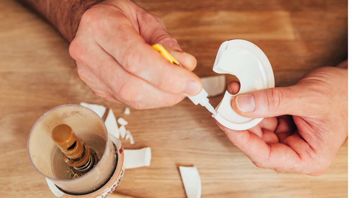 Man using superglue to fix broken item