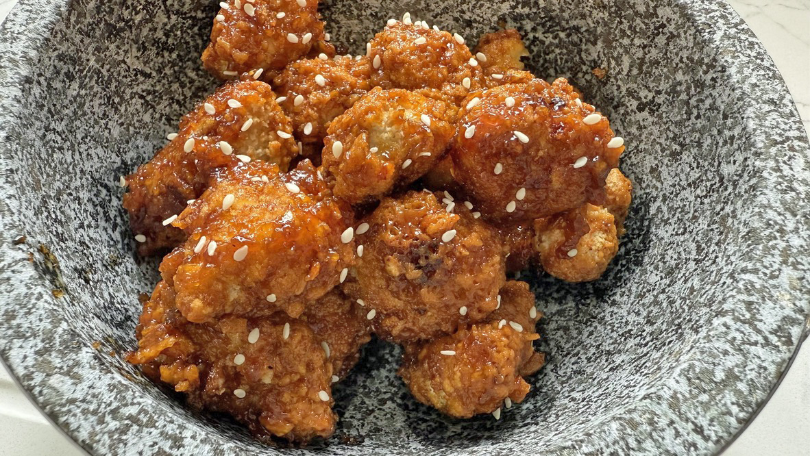 Air fryer sesame chicken with sesame seeds in bowl