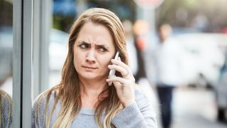Woman on the phone looking annoyed