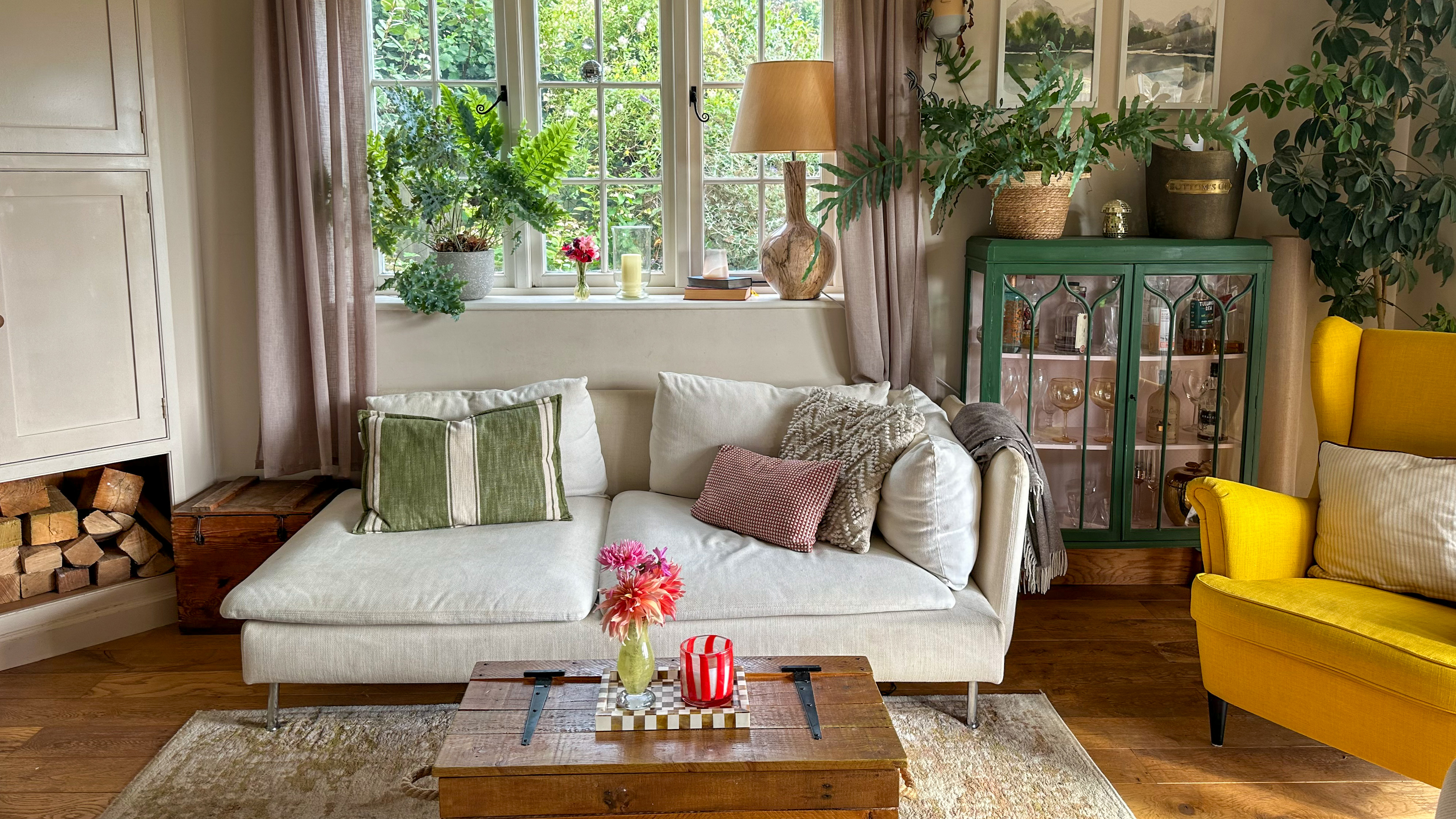 country-style living room with white sofa and yellow chair and lots of cushions