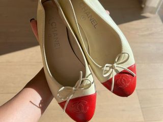 Tan Chanel flats with a red cap toe