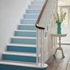 painted stairs with flower vase and white wall