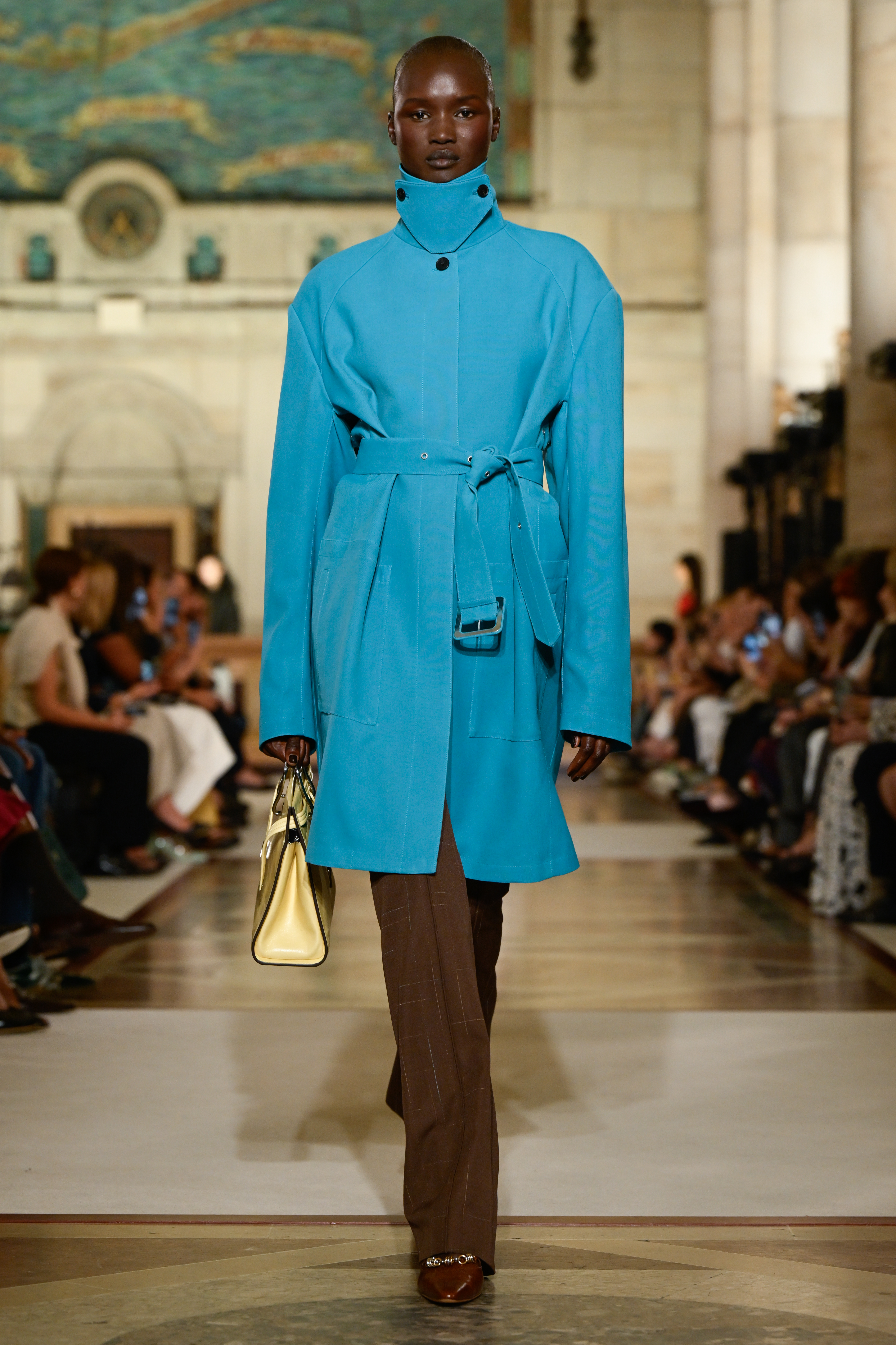 Tory Burch Spring Summer 2026 Turquoise Trench over Brown Pants