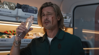 Brad Pitt holding a bottle in Bullet Train.