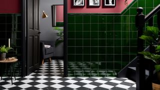 hallway with green wall tiles and black and white floor tiles