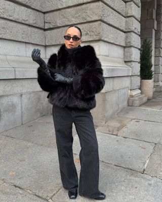 Fashion influencer @ingridedvinsen wears a chic and practical look with long leather gloves that's on-trend for 2025.