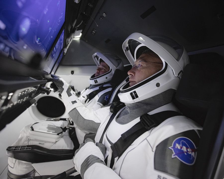 NASA astronauts Doug Hurley (foreground) and Bob Behnken (background) train in a simulator for SpaceX&#039;s Crew Dragon, getting used to the touchscreen controls