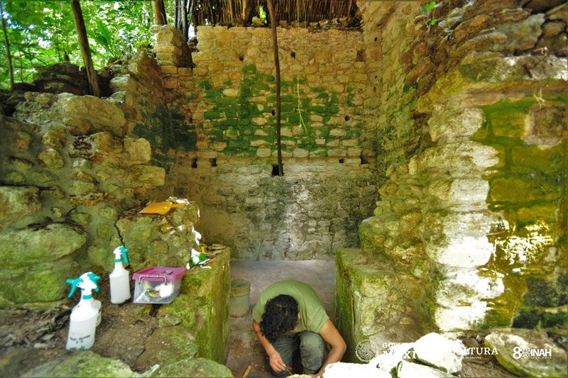 An excavator examines the palace's remains.