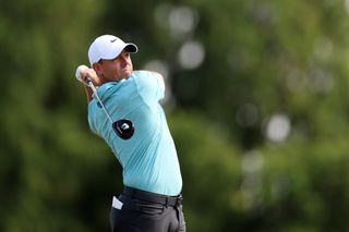 Rory McIlroy hits a fairway wood