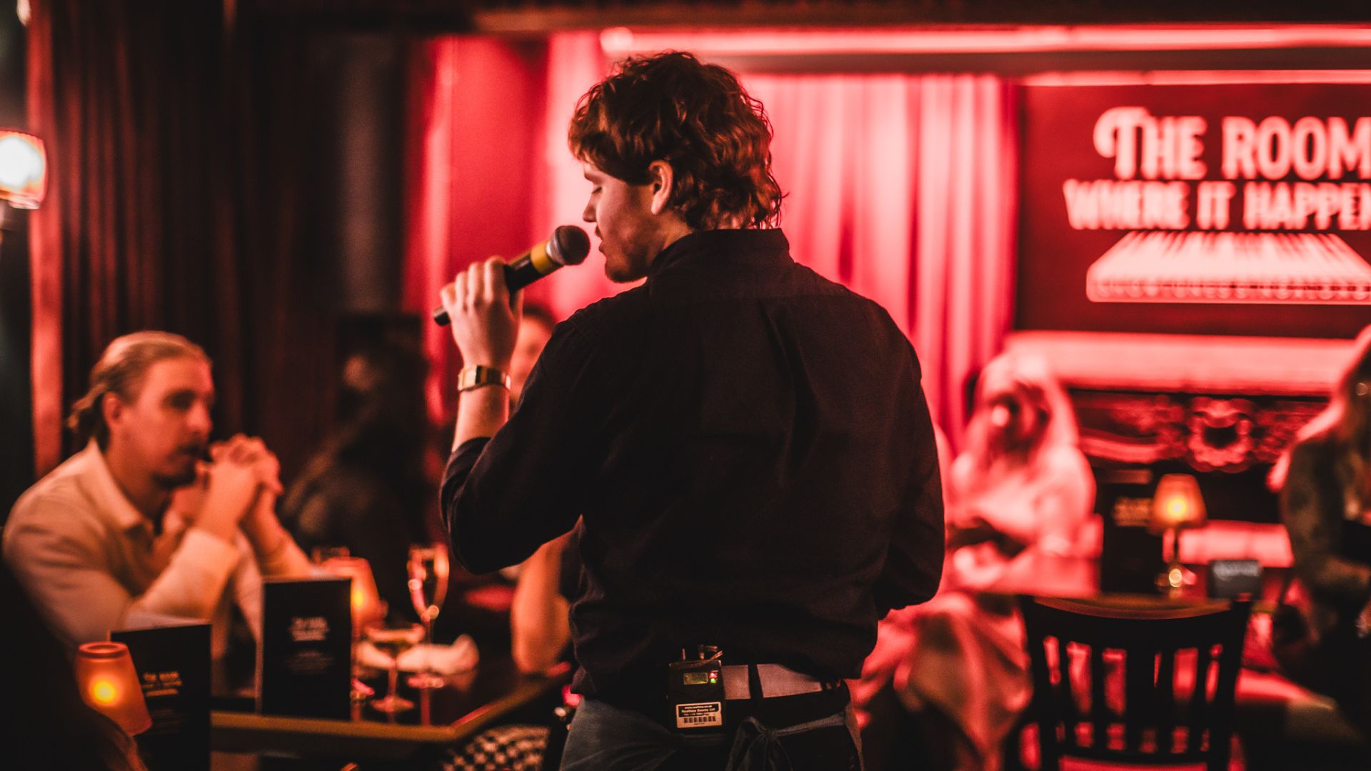 a waiter singing in the middle of the room