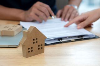 A woman signing a mortgage contract