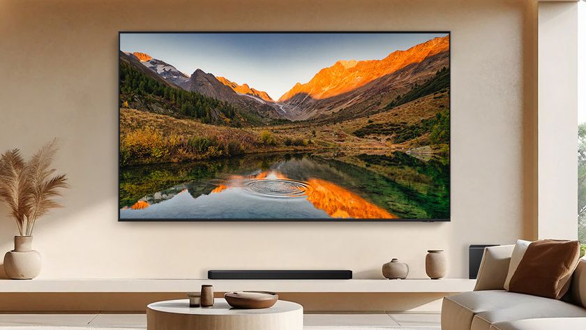 The 115-inch Samsung QN90F Neo QLED TV in a beige living room.