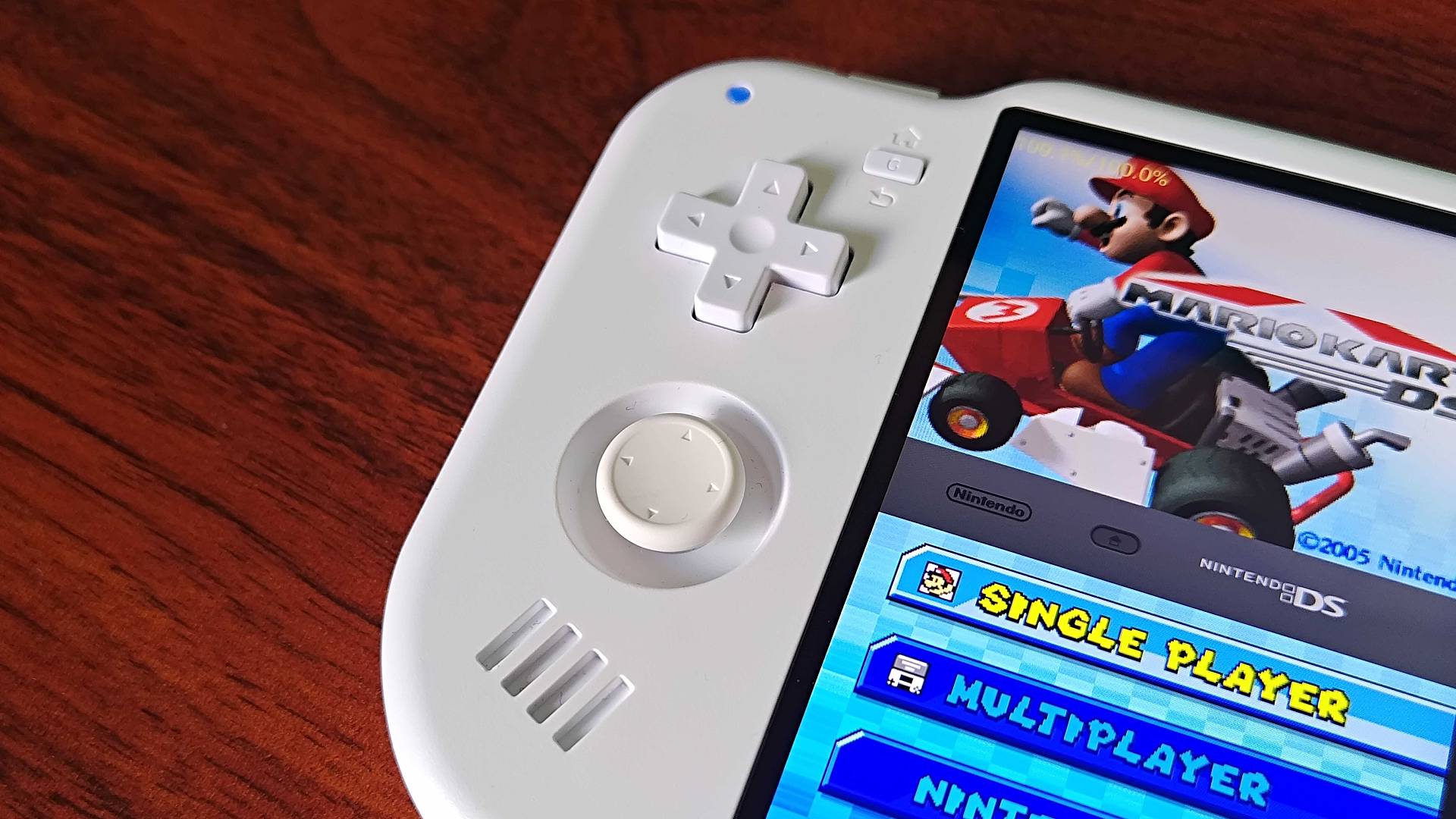 Close up of MagicX Zero 40 d-pad and thumbstick sitting on woodgrain desk.