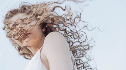 picture of girl with curly hair - hair hormone health