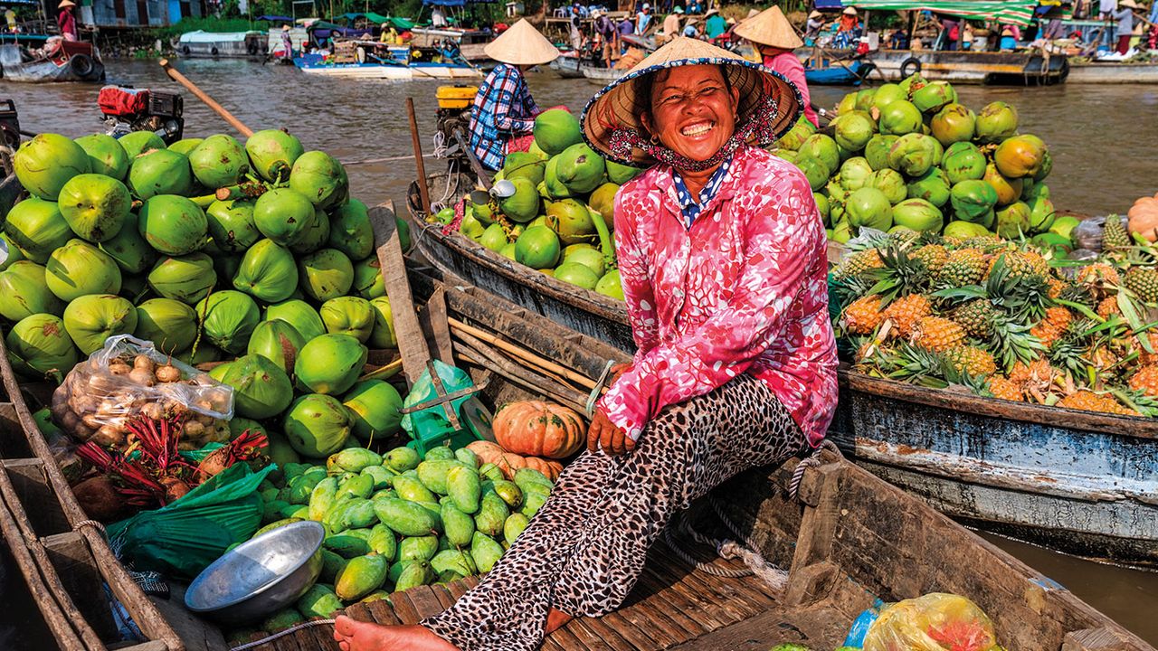 Vietnamese woman selling fruits on floating market