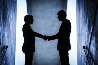 Abstract image of two people shaking hands on a deal