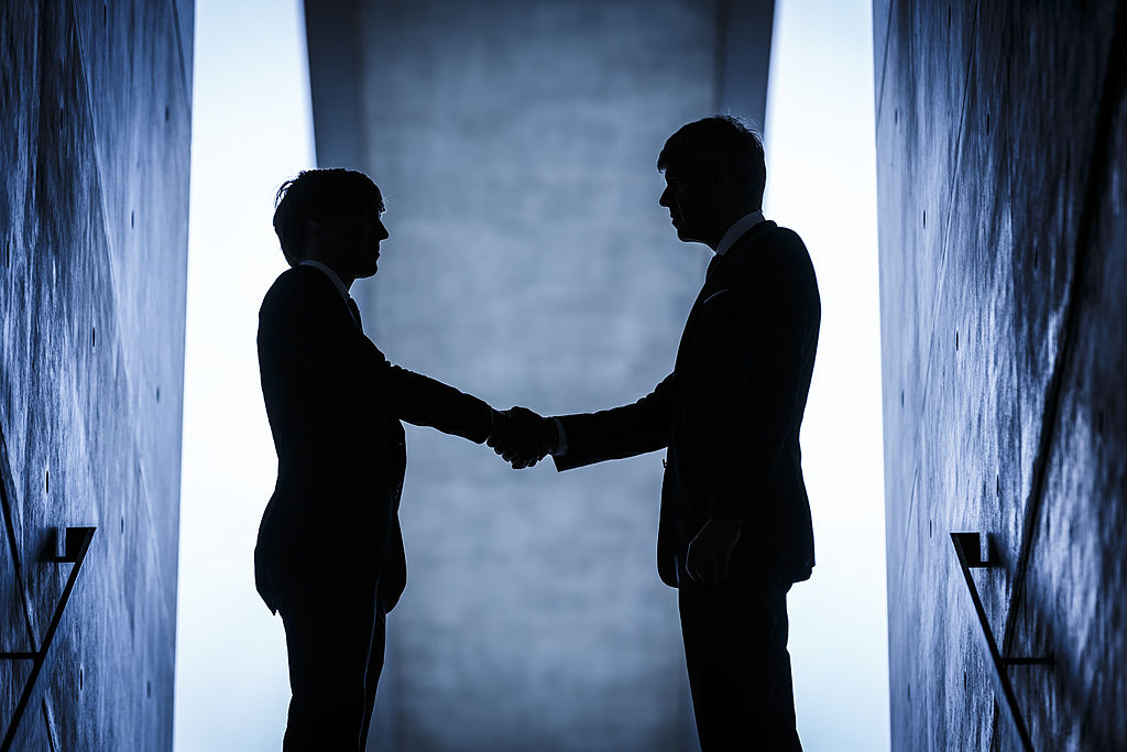 Abstract image of two people shaking hands on a deal