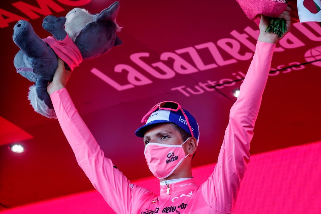 Team Deceuninck rider Portugals Joao Almeida wearing a face mask celebrates on the podium after receiving the pink jersey in the 8th stage of the Giro dItalia 2020 cycling race a 200kilometer route between Giovinazzo and Vieste on October 10 2020 Photo by Luca Bettini AFP Photo by LUCA BETTINIAFP via Getty Images