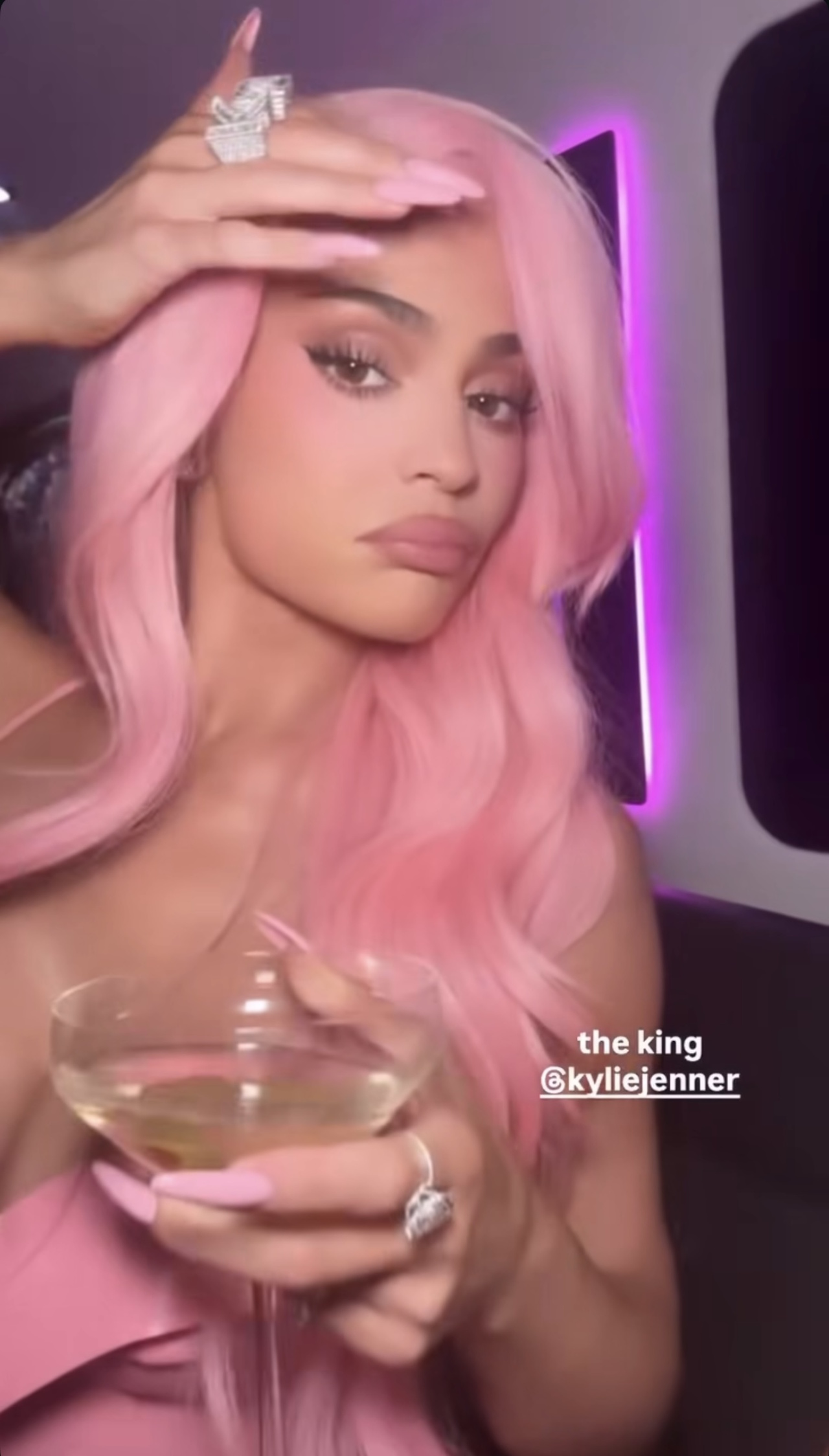Kylie Jenner shows off her pink &quot;King Kylie&quot; wig while drinking a cocktail at the 10th anniversary celebration of Kylie Cosmetics.