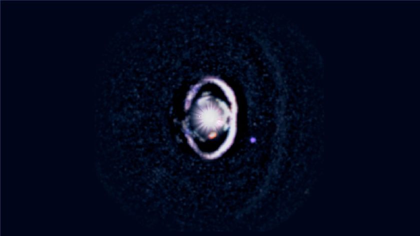 WISPIT 2b appears as a small purple dot beside a bright white dust ring encircling its star, with a fainter outer ring visible beyond it in new observations from the Magellan and Large Binocular Telescopes. 