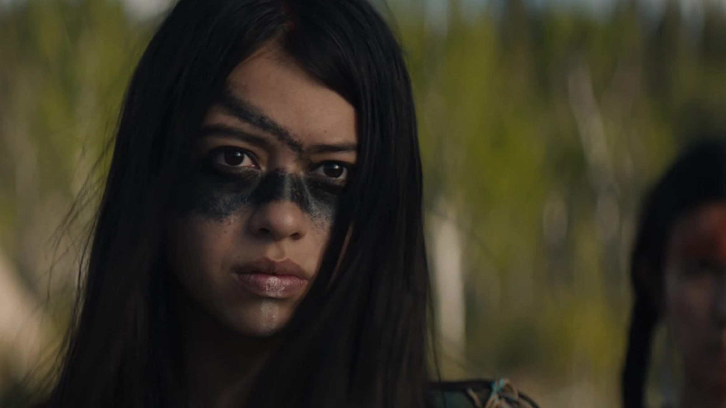 A close-up of the film's lead character Naru, a skilled Comanche warrior, played by Amber Midthunder.