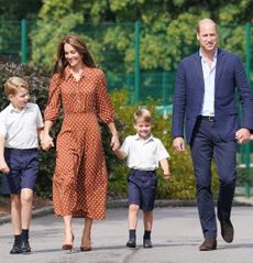 Prince George, Princess Charlotte, Prince Louis holding hands with Princess Kate and Prince William and wearing school uniforms walking to school