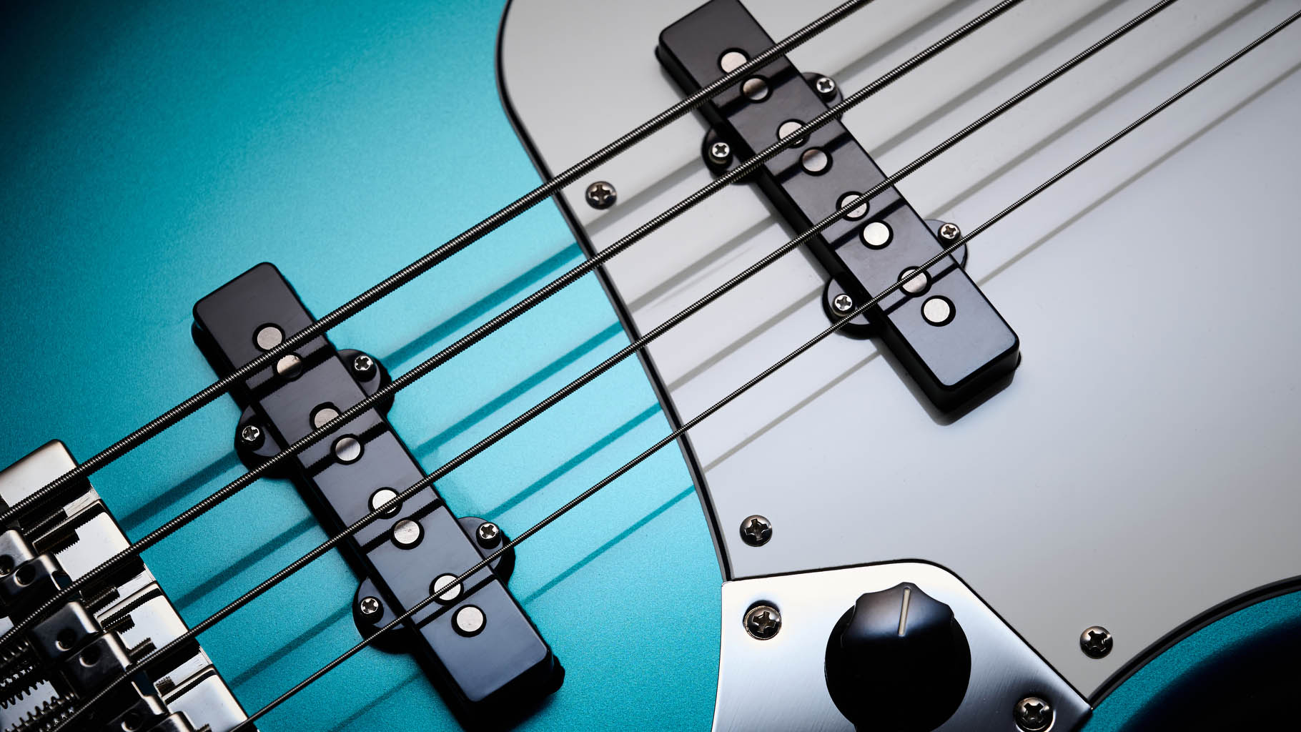 Squier Classic Vibe 70s Jazz Bass Active: finished in Ocean Turquoise, this keenly priced four-string is photographed in close-up with a patterned rug and wooden floor in the background.