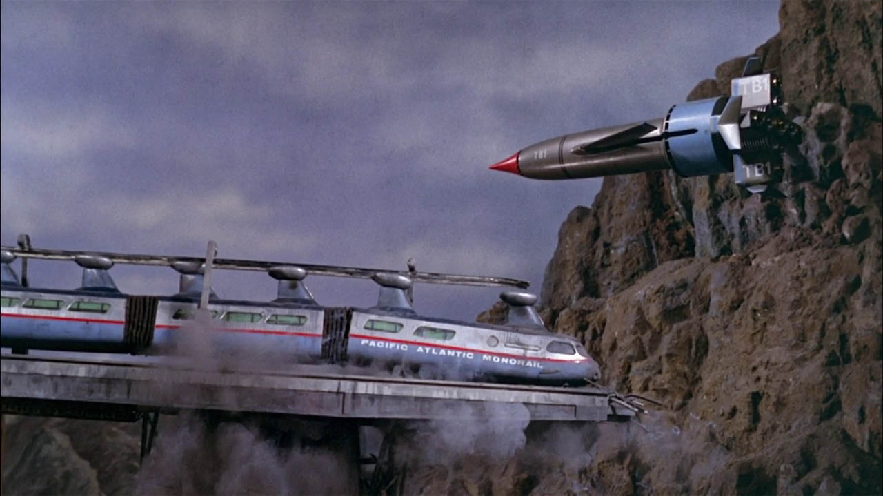 Screenshots from Thunderbirds showing Thunderbird 1 hovering near a crashed train.
