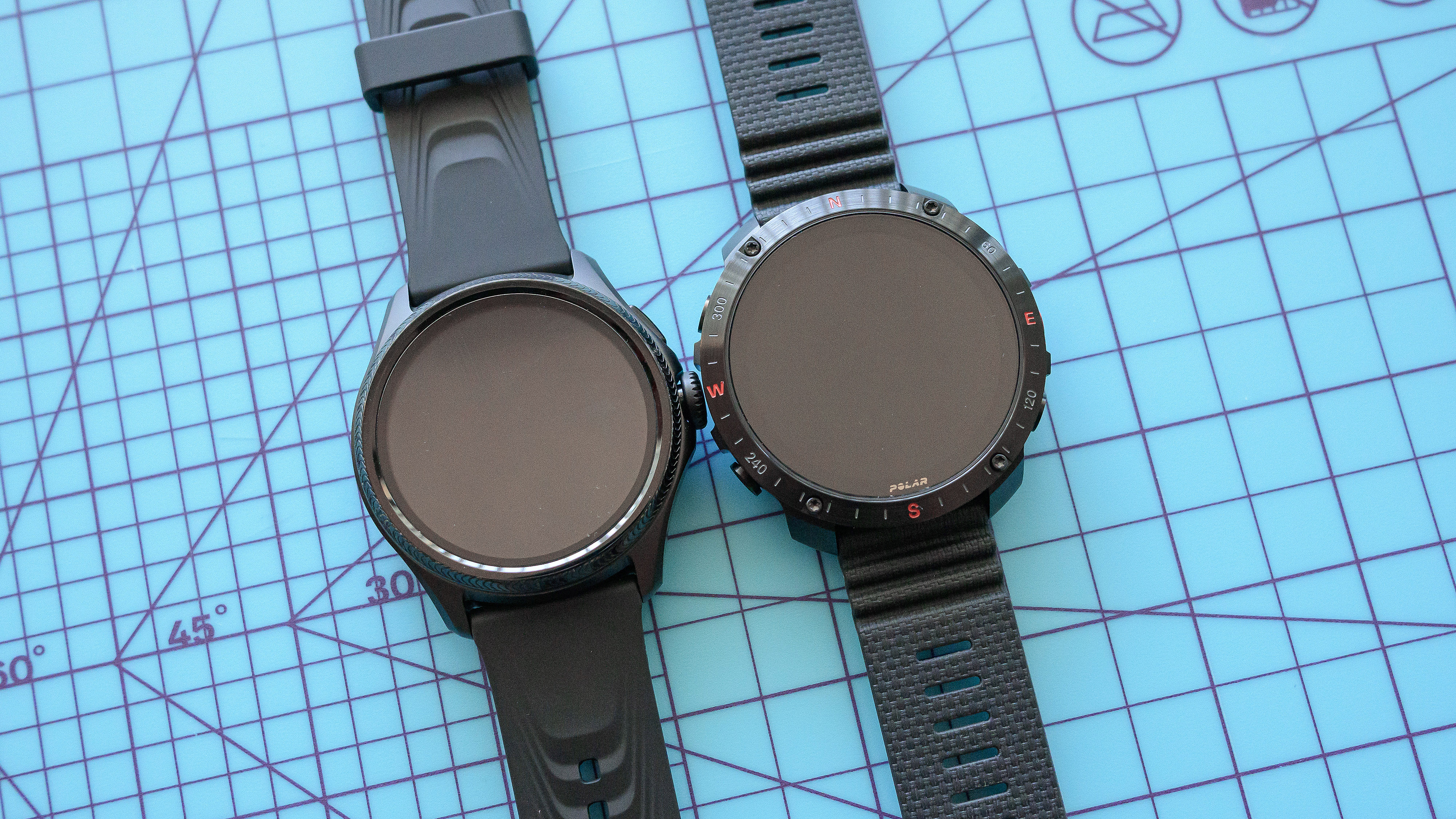 The TicWatch Pro 5 Enduro and Polar Grit X2 Pro on a mat