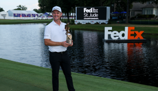 Justin Rose holds a trophy
