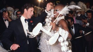 RIO DE JANEIRO, BRAZIL - 1978: Prince Charles, Prince of Wales dances with a Samba dancer at a party at the Town Hall in 1978 in Rio de Janeiro, Brazil.